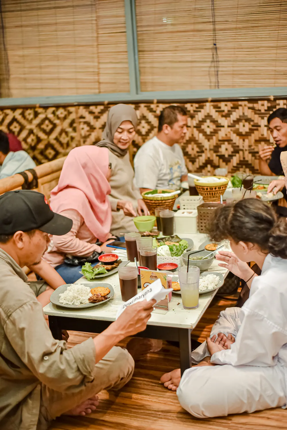 Area lesehan lantai 2 Sibabah Kota pada malam hari dengan dinding anyaman bambu